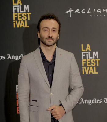 Man standing in front of black LA Film Festival backdrop