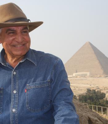 Dr. Zahi smiling in front of the Pyramids in Egypt