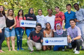 Group of students holding two Fulbright signs