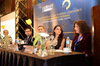 Five panelists at a table
