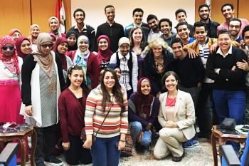 Large group of Egyptian college students group together and smile at the camera