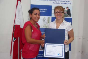 Two women hold up CAPM certificate