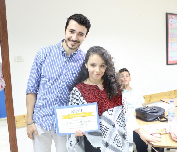 Student and teacher holding course certificate
